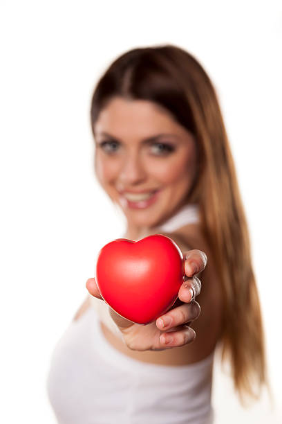 istock Happy woman holds in her hand a heart shape object 466625434