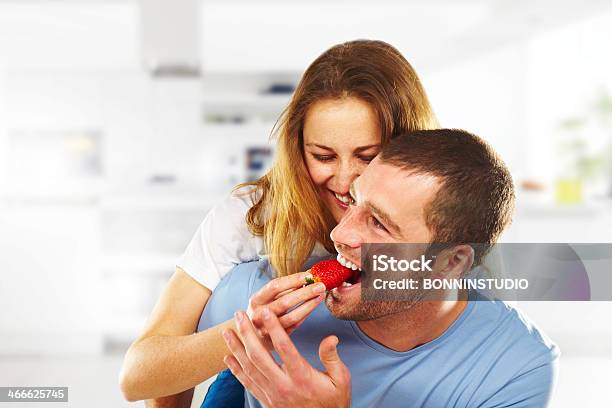 Happy Young Couple Eating Strawberries Together Stock Photo - Download Image Now - Strawberry, Eating, Couple - Relationship