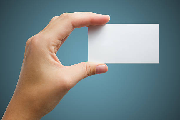 istock Hand holds a white business card on a blue background 466629294