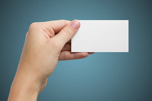 istock Hand holds a white business card on a blue background 466629296