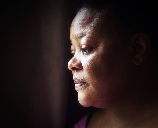 portrait of mature woman of African descent with thoughtful expression stock photo