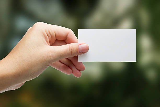 istock Hand holding white business card on blurred background 466630492