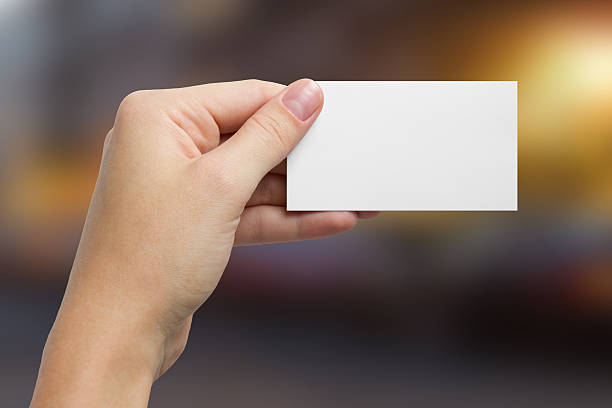 istock Hand holding white business card on blurred background 466630528