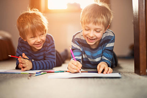 istock Little brothers enjoying drawing together 466633402