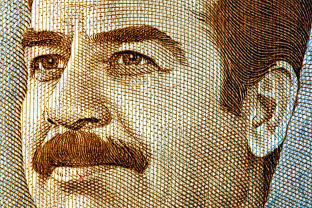 A close up shot of the face on an old Iraqi dinar.