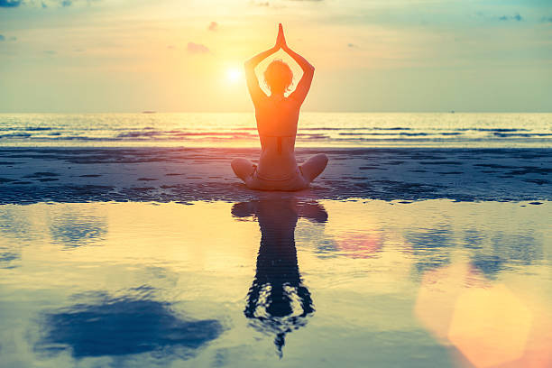 istock Silhouette young female practicing yoga 466640874