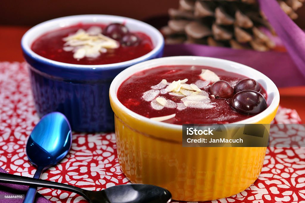 Danish berry jelly dessert (Rodgrod med flode) Traditional Danish berry jelly made from assortment of red fruit and starch. Before eating, liquid or whipped cream is added on top. Danish name of the dish is "Rodgrod med flode" Cherry Stock Photo