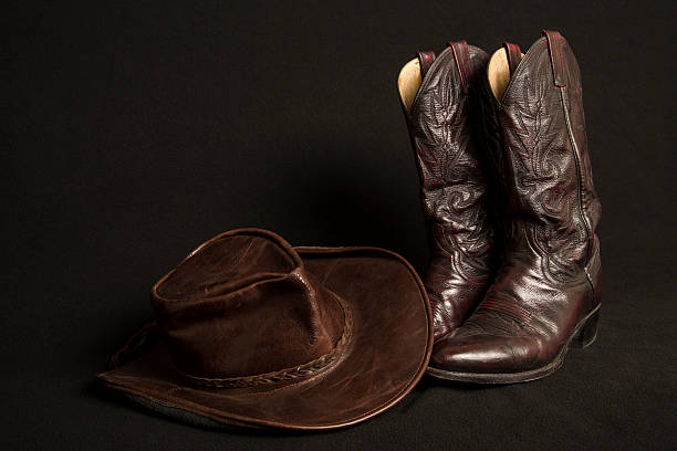 istock Cowboy boots and cowboy hat on black background 466647734