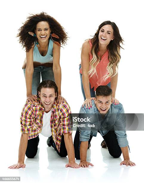 Four People Doing A Human Pyramid Stock Photo - Download Image Now - 20-24 Years, 20-29 Years, 2015