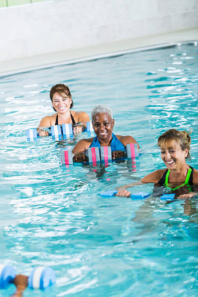 istock Multiracial women in water aerobics exercise class 466656756