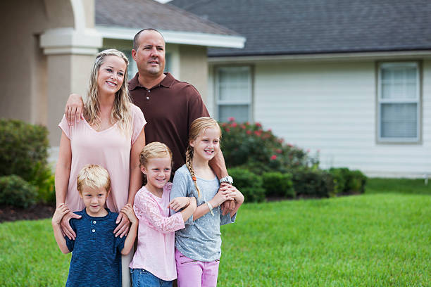 istock Family with three children standing in yard 466656996