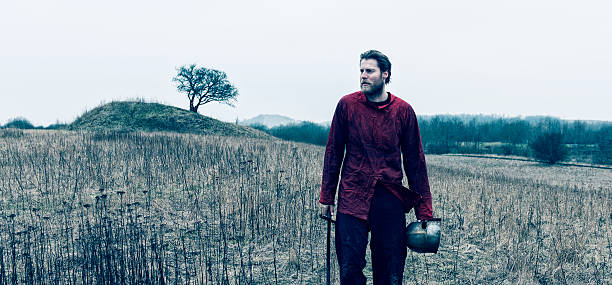 istock Viking warrior walks alone with sword and helmet 466657184