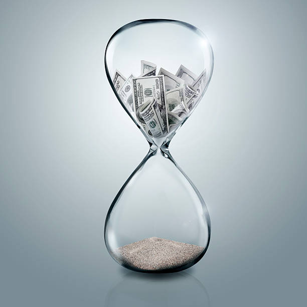 istock Money in glass sand 466663236
