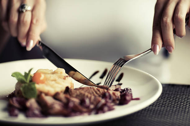 istock Female hands with a dinner at restaurant 466663508