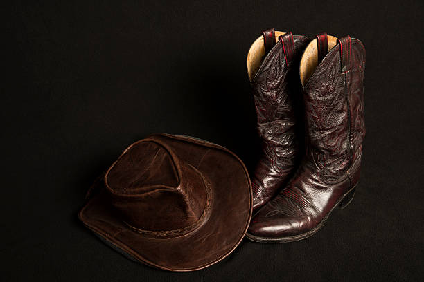 istock Cowboy boots and cowboy hat on black background 466665866