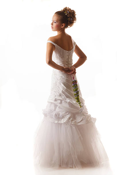 istock Young stylish bride holds a designers bouquet behind her back 466666142