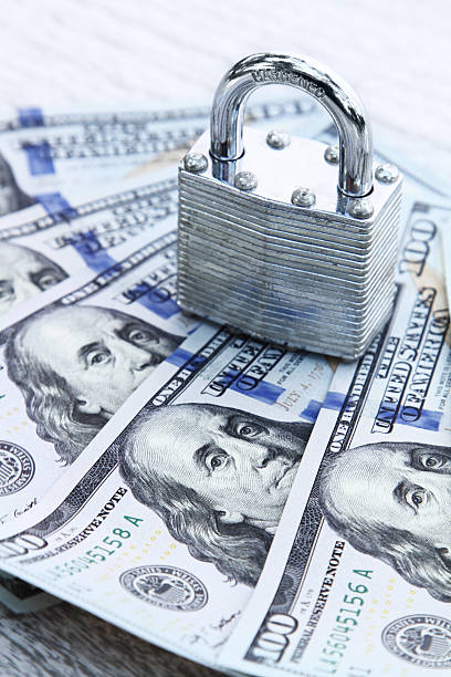 istock Padlock on group of 100 dollar bills 466666328