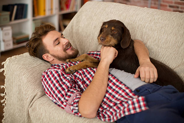 istock Young man at home with his dog. 466666466