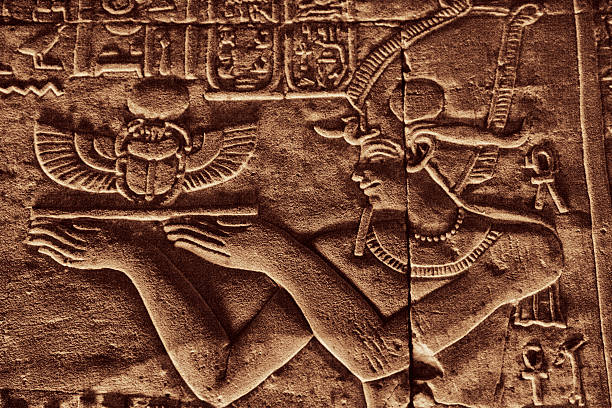 Ancient Hieroglyphics Ancient Hieroglyphics - Egyptian Priest Carrying a Tray with Scarab. scarab beetle stock pictures, royalty-free photos & images