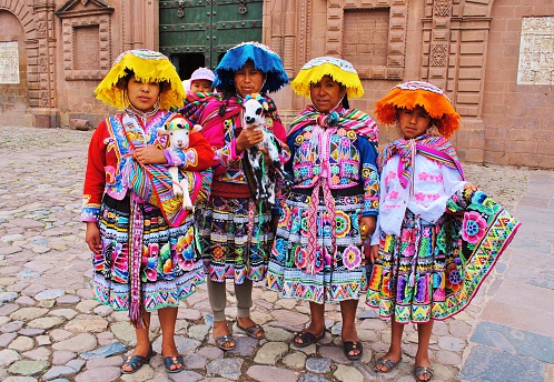 Cusco, Peru - April 26, 2014: Peruvian family in traditional dress with baby alpaca