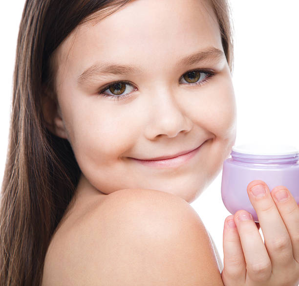 istock Girl applying cosmetic cream 466668608