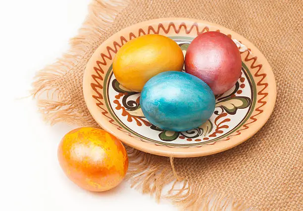 Photo of painted eggs for Easter, in plate on canvas