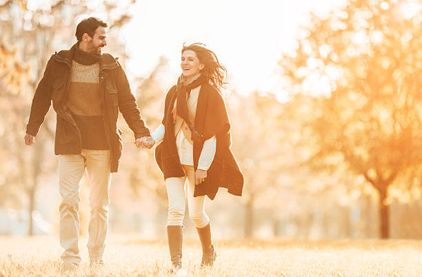 istock Couple running in autumn day at sunset and having fun. 466671590