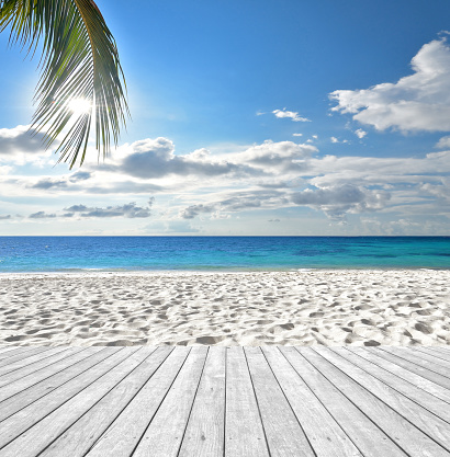 Sunny beach and empty wooden platform