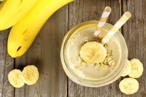 istock Banana oatmeal smoothie downward view on wood 466673390