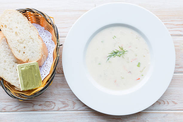 Fluffy herb soup with salmon in a white plate stock photo