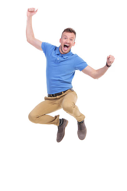 istock casual young man jumps in the air 466676898