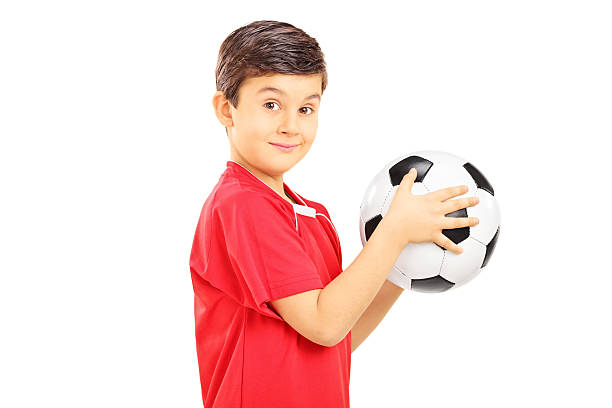 istock Young boy holding a soccer ball 466680099