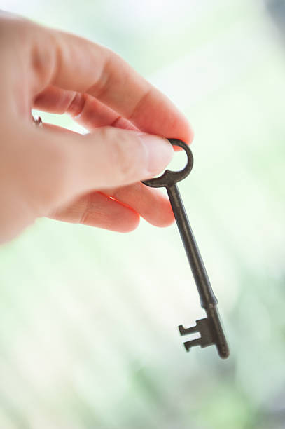 istock Woman Hand Holding An Antique Key 466680667