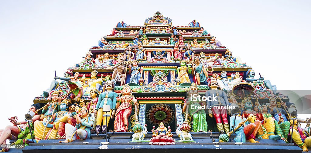 Hindu Sri Mariamman Temple in Singapore City The image shows the entrance tower (gopuram) of the Hindu Temple covered with the statues of deities. The statues are made of plaster and have been brightly painted. Architectural Feature Stock Photo