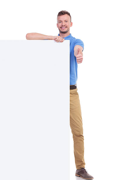 istock casual young man with pannel shows thumb up 466681616