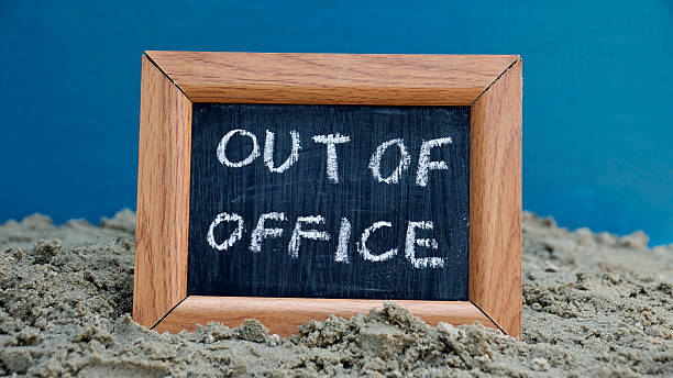 Small blackboard in a frame with Out of Office on it stock photo