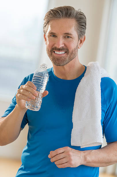 istock Mature Man Drinking Water From Bottle After Exercising 466683571