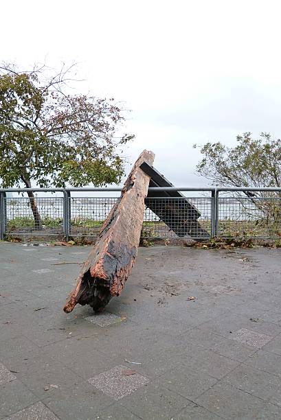 East River Park NYC Post Hurrican Sandy Large Debris East River NYC Post Hurricane Sandy Skyline pilings water path grass debris hurrican stock pictures, royalty-free photos & images