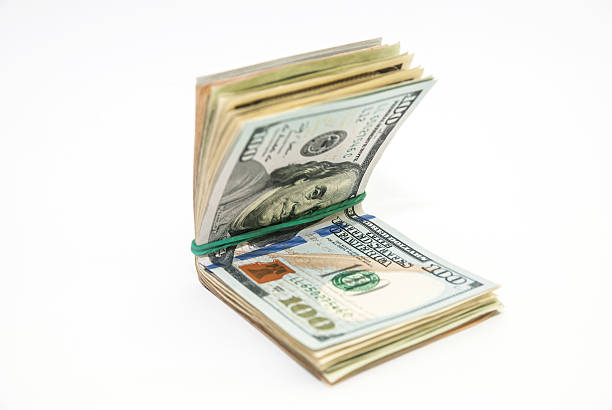 istock US Dollars tied with a rubber band isolated, white background 466684100