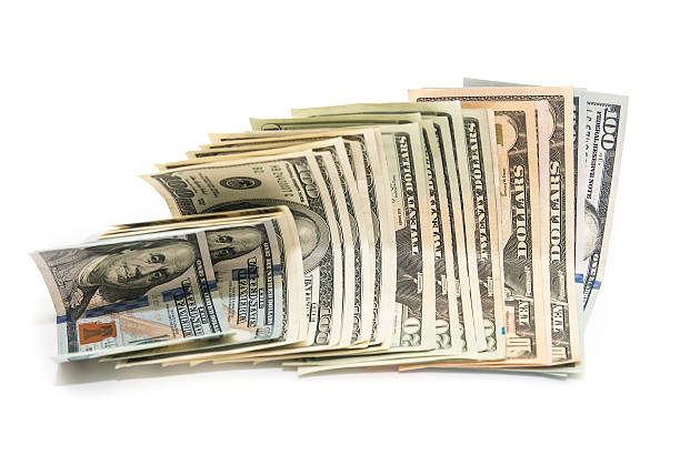 istock US Dollars tied with a rubber band isolated, white background 466684116