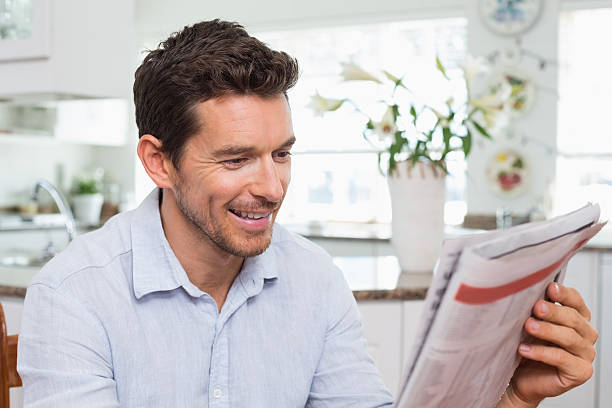 istock Man reading newspaper at home 466684584