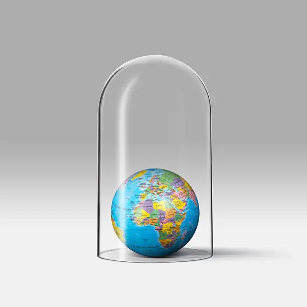 A glass is protecting the earth which is showing Europe and Africa continent.