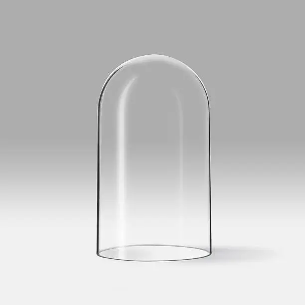 An empty and transparent glass stands upside down on a grey background.