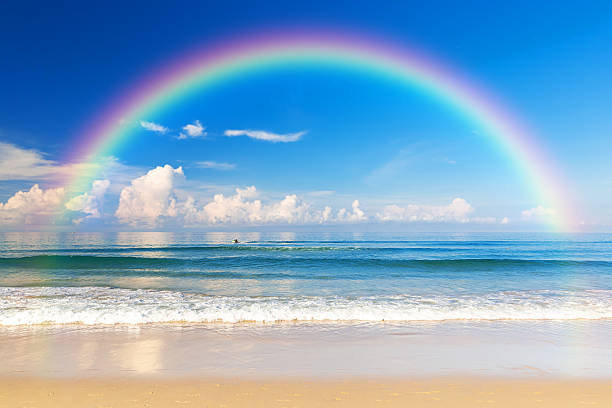 Beautiful sea with a rainbow in the sky stock photo