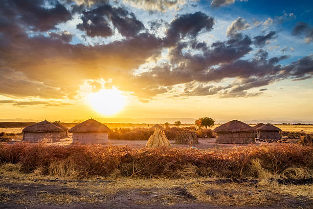 Maasai village by Sunset - Tarangire National Park View of Maasai village with huts and enkang barrier nearby Tarangire National Park - Tanzania. masai stock pictures, royalty-free photos & images