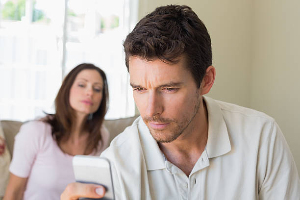 istock woman looking at man text messaging 466692278