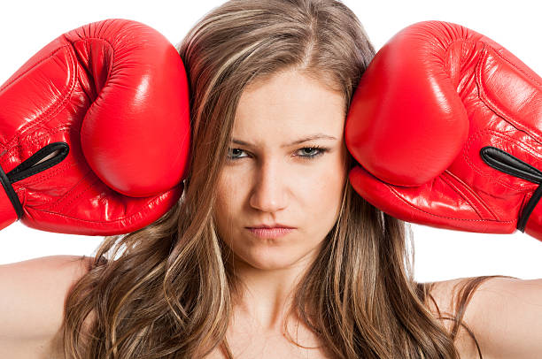 istock Beautiful female model with boxing gloves and serious face 466694502