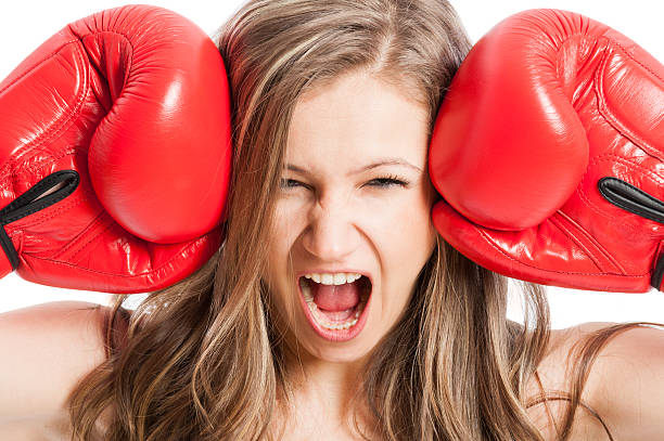 istock Female model wearing red boxing gloves screaming or shouting 466694638