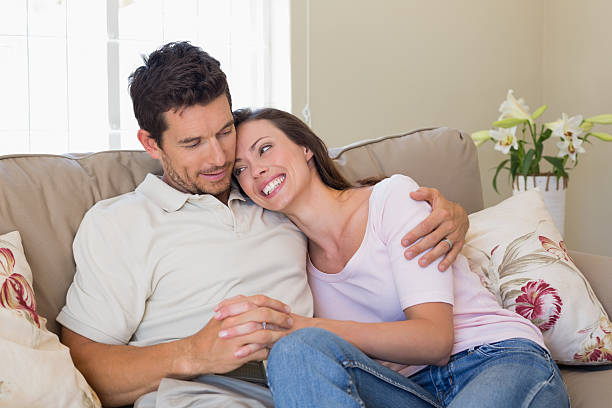 istock Loving couple sitting on couch at home 466694706