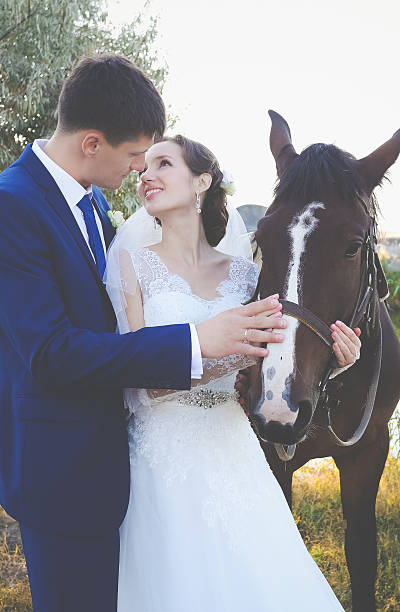 istock Young bride and groom in the stables on the wedding day 466694966